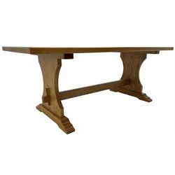 Medium oak rectangular dining table, raised on shaped end supports united by pegged stretcher, on sledge feet