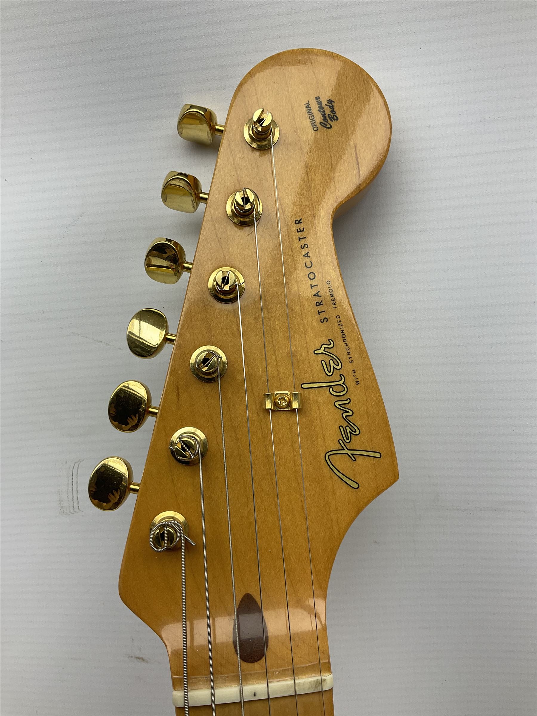 Fender Stratocaster 50th Anniversary 2004 metallic gold electric guitar; serial no.MZ4116369; L98cm; in Spider fitted case with owners manual and other paperwork, strap and belt buckle etc