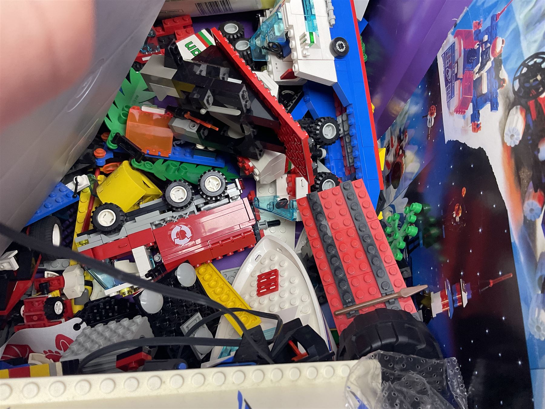 Lego - large quantity of part-built models and loose component parts including Lego Technic and Lego System, space and road vehicles, ships and boats, helicopter etc; together with two set boxes and folder  containing large quantity of instruction booklets; stored in two very large plastic boxes