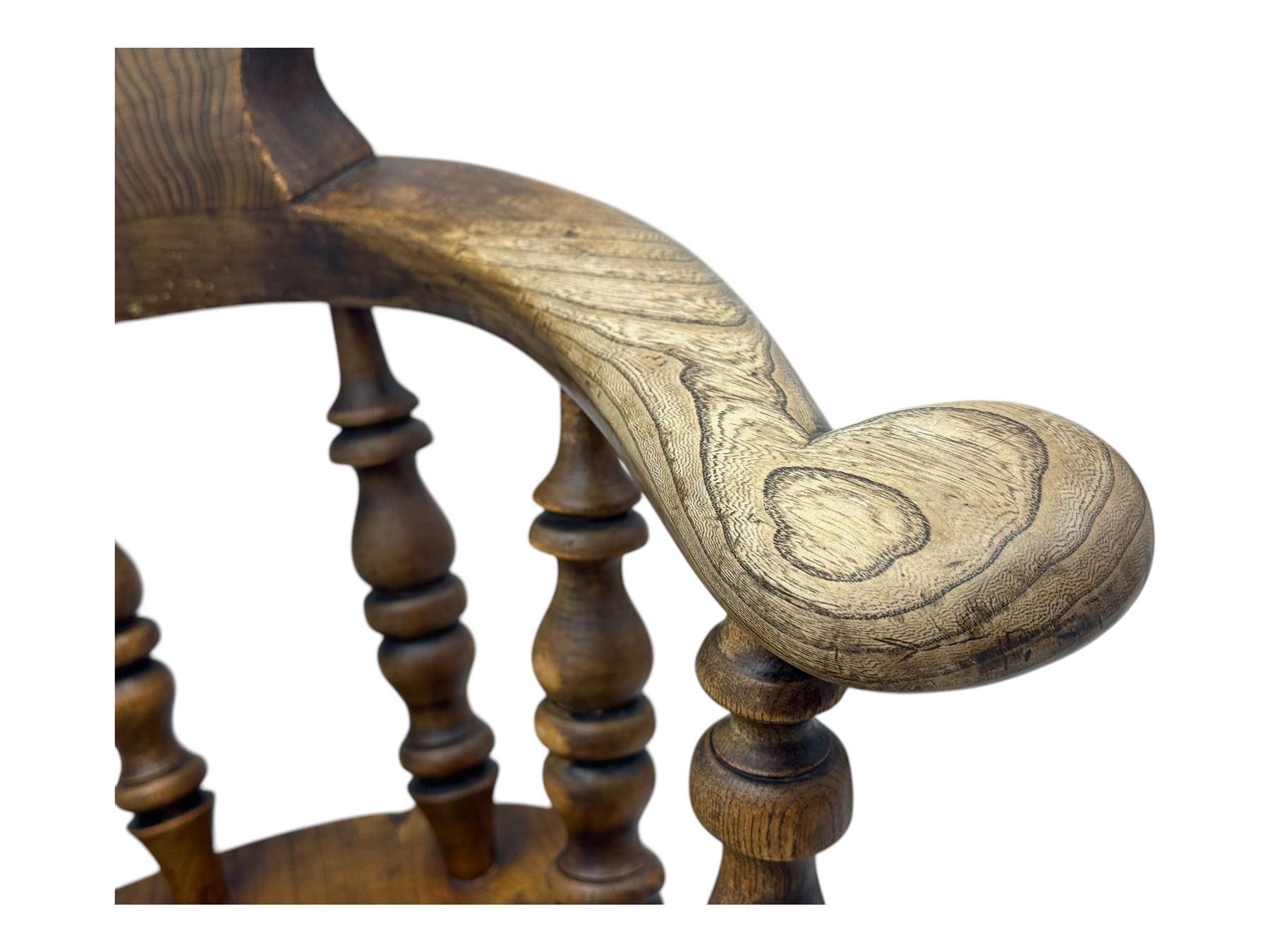 19th century elm and beech smoker's bow armchair, shaped arms over turned spindle gallery and dished seat, on turned supports united by double H-shaped swell turned stretchers 