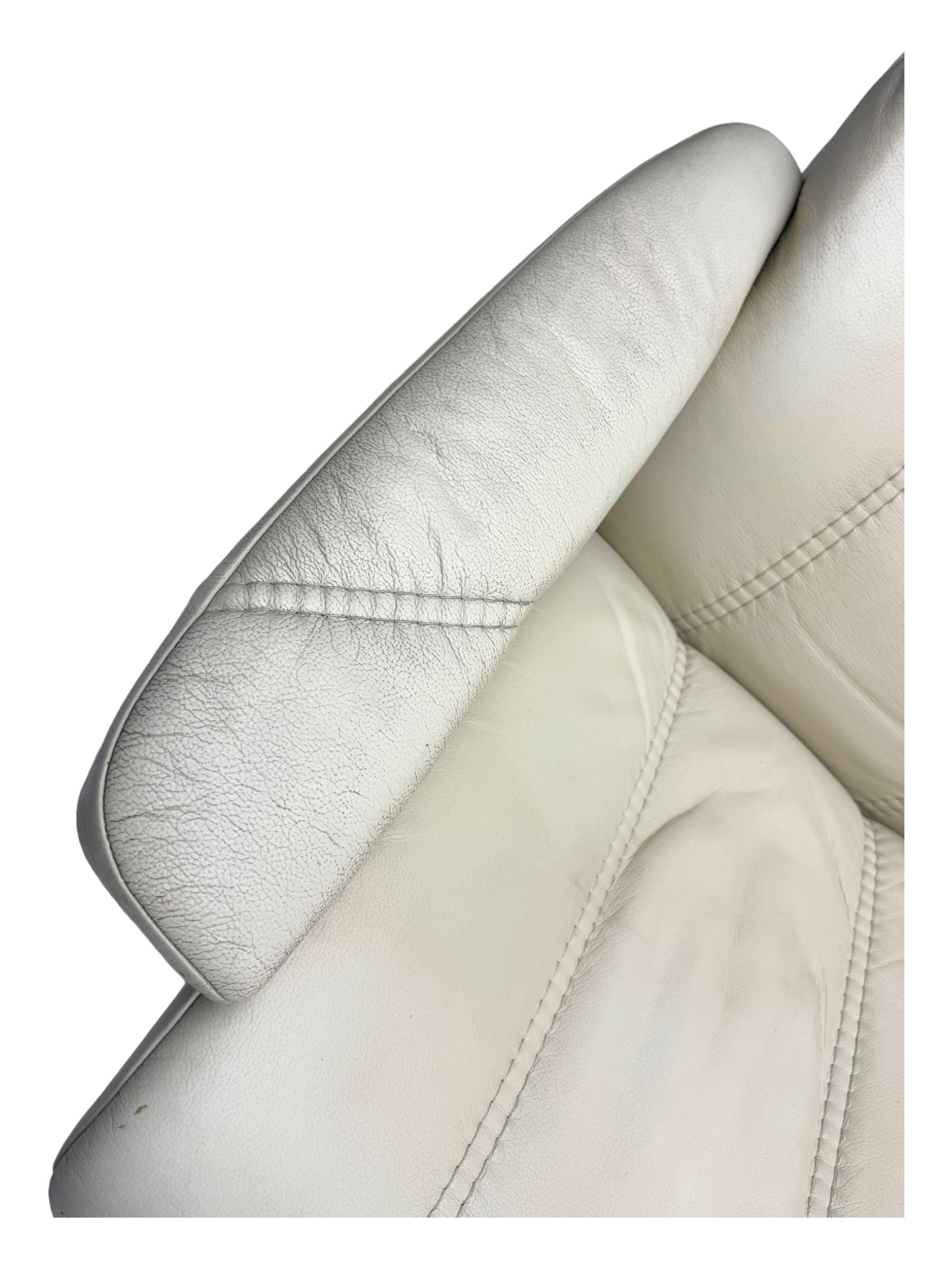 Ekornes Stressless - swivel and reclining armchair upholstered in cream leather, high back and padded armrests, raised on circular base