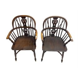 Pair late 20th century oak Windsor elbow chairs, double hoop and stick back with pierced and fretwork work splat, dished seat on turned supports joined by crinoline stretcher