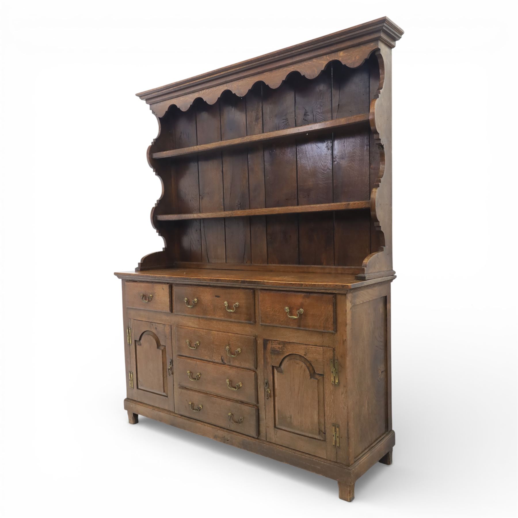 Georgian design oak dresser, the raised plate rack with shaped sides and two open shelves, upon a dresser base fitted with six drawers and two cupboard doors, and short block feet 