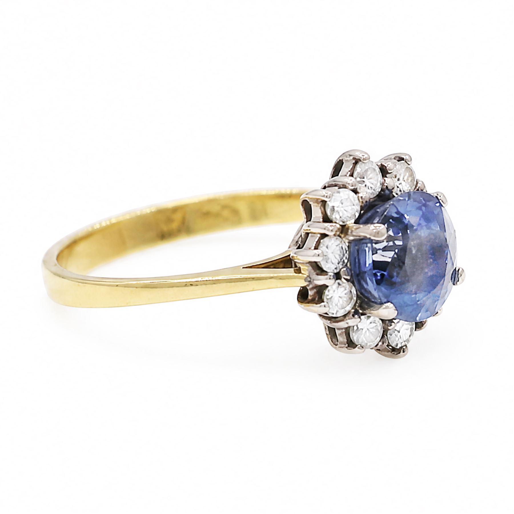 18ct gold sapphire and diamond cluster ring, oval cut sapphire of approx 1.50 carat, surrounded by ten round brilliant cut diamonds, Birmingham import mark 1981, total diamond weight approx 0.30 carat