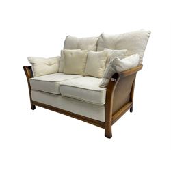 Pair mid-to late 20th century stained beech two seat sofas, upholstered in cream fabric