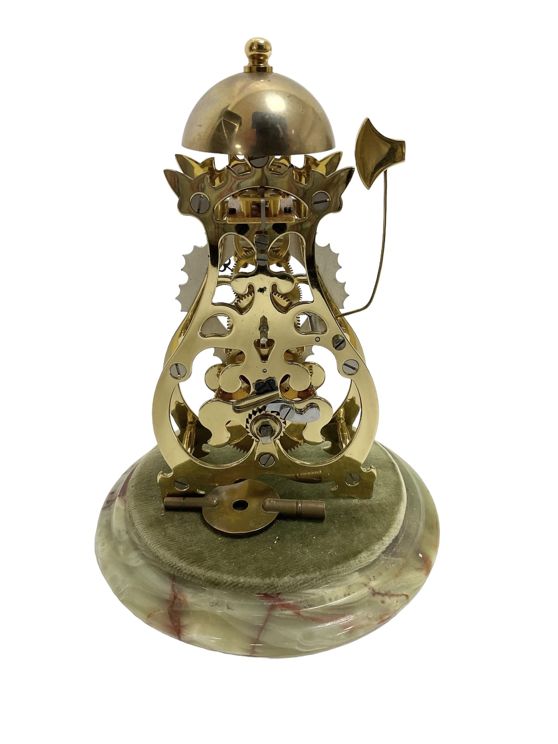 Thwaites & Reed - Small 20th century skeleton clock with a glass dome and stepped onyx base,  pierced movement frames with a silver chapter ring, Roman numerals, minute markers, and steel hands, domed brass bell with passing strike on the hour, with a lever platform escapement, wound and set from the rear. With key.