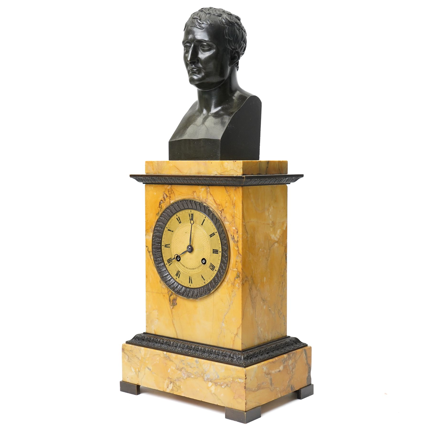 French-First quarter 19th century 8-day sienna marble and bronze-mounted mantel clock of rectangular architectural form, with patinated foliate guilloche pattern cast bronze mounts  in richly figured sienna marble, surmounted a by a classical patinated bronze bust of Napoleon Bonaparte, above a gilt engine turned dial with Roman numerals and blued steel hands, with a twin train Parisian countwheel striking movement, striking the hours and half-hours on a bell, silk suspension with thumb-screw adjustment. With pendulum.