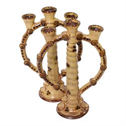 Pair of studio pottery candlesticks, with a central twisted column bordered by circular supports, H24cm 