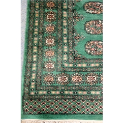  Bokhara green ground rug, geometric patterned field, 244cm x 158cm  