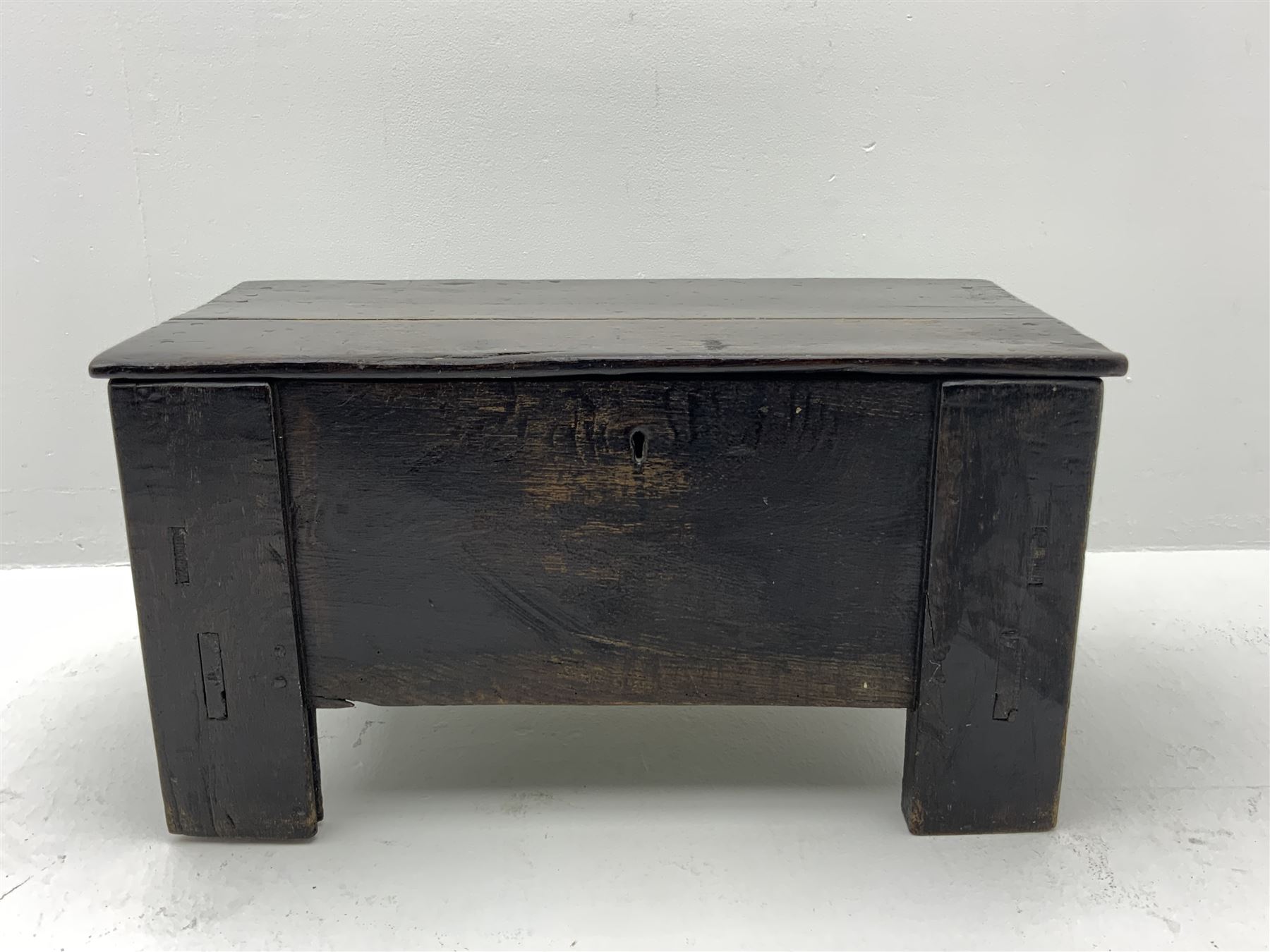 17th century vernacular oak boarded and joined clamp-front coffer or ark chest, enclosed by hinge lid, vertical stile supports