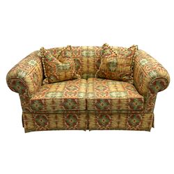 Two seat traditional shape sofa upholstered in Kilim print fabric, with scatter cushions