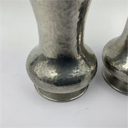 Pair of Liberty & Co Tudric pewter vases, each of bellied form with hammered finish, upon a circular spreading foot, impressed beneath 0987, H12cm