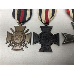 Two WW1 German medals - copy Cross of Honour with swords (combatants); Cross of Honour without swords (non-combatants); and two WW2 German medals - War Merit Medal; and War Merit Cross; all with ribbons (4)