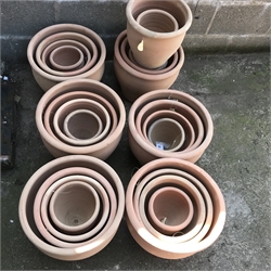 A quantity of approx. twenty four tapering terracotta pots - various sizes