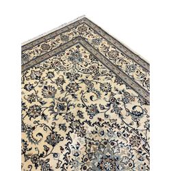 Central Persian Nain rug, wool with silk inlay, ivory ground decorated with scrolling and interlaced branch with stylised plant motifs, central floral medallion, triple band border with repeating design