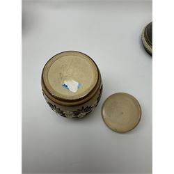 A group of Doulton Lambeth and Royal Doulton tobacco jars, to include examples with relief moulded foliate decoration, each with impressed marks and markers monograms beneath. 