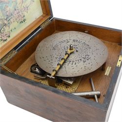 German-late 19th century Polyphon, in a mahogany finished case with a decorative inner Kalliope trade decal, with a 48 tooth steel comb on a gilt cast base and central driving spindle, with six bells and hammers and one 9-1/8” disc. Serial No 113007. With Key.