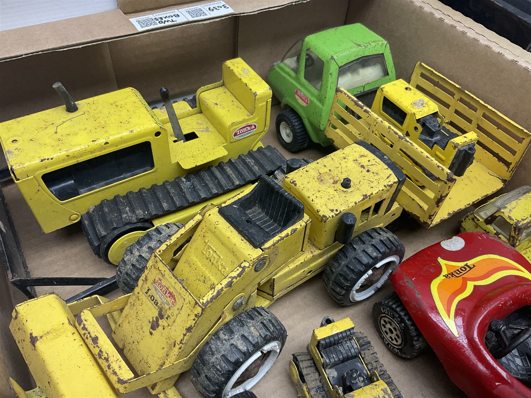 Tonka - fourteen pressed steel vehicles including Pick-up Truck, Tractor Digger, Mobile Crane, Trencher, Beach Buggy, two Bulldozers, Digger, Low Loader, Farm Trucks etc; and small quantity of spare parts (14)