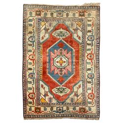 Anatolian Turkish ivory ground carpet, the central geometric pole medallion within an amber field, the guarded border decorated with stylised plant motifs surrounded by bands of repeating flower heads