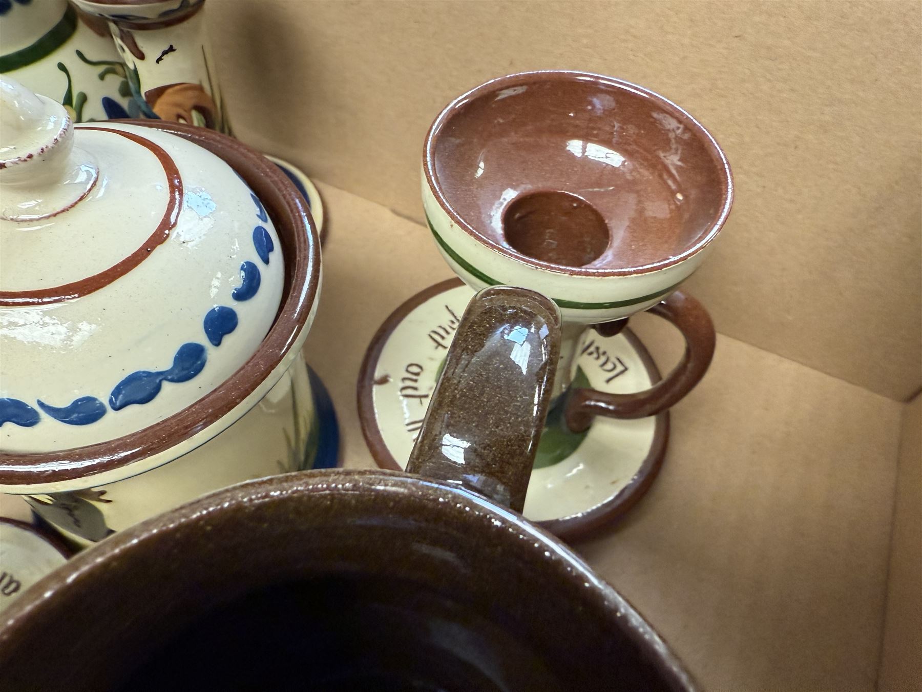 Collection of Torquay and similar Motto ware, including jugs, candlesticks, twin handled mug etc 