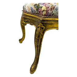 Pair of Louis XV-design giltwood stools, each upholstered in floral tapestry fabric, the carved frame adorned with scrolling foliage and shell motifs, raised on cabriole supports