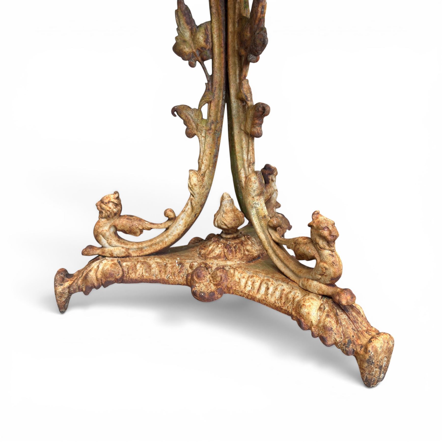 Victorian cast iron garden table, circular pierced top with foliate and scroll decoration, raised on an ornate tripod base with natural weathered paint finish.