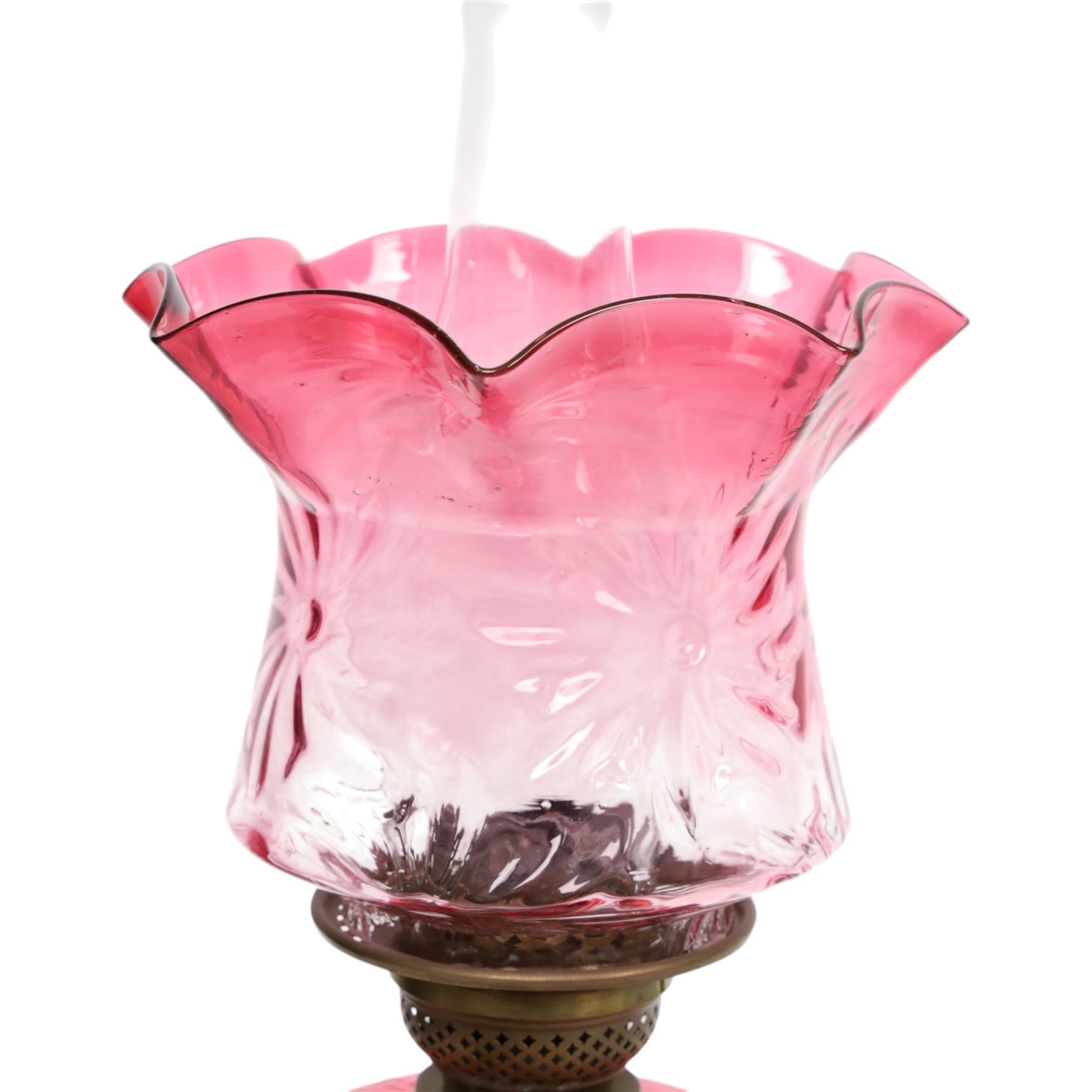 Victorian oil lamp, the brass base supporting cranberry glass reservoir, with clear glass chimney and cranberry shade with fluted rim, overall H59cm
