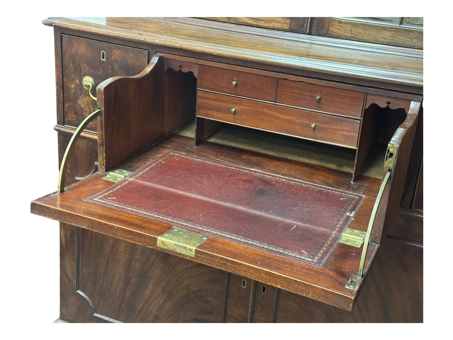 George III mahogany bookcase secretaire, dentil cornice over blind fret work frieze, enclosed by two astragal glazed doors, central secretaire drawer with fall front enclosing leather writing surface and small drawers, two flanking short drawers over double cupboard, on bracket feet