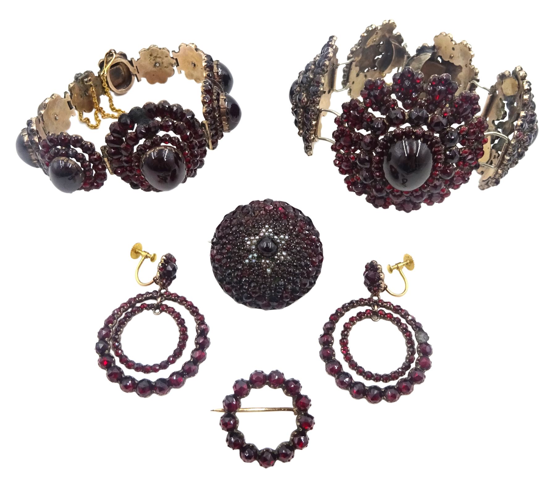 Victorian Bohemian garnet jewellery including two graduating oval cluster bracelets, pair of screw back pendant earrings and two brooches