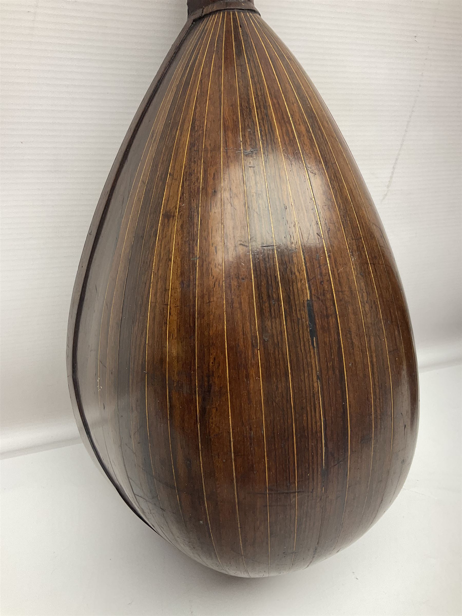 Late 19th century Italian lute back mandolin with segmented bowl back, bears label Gennaro Maglioni Napoli L61cm; in ebonised wooden case; together with another similar damaged Italian lute back mandolin for restoration or spares (2)