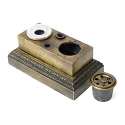 19th-century Grand Tour patinated bronze inkwell, surmounted by a recumbent lion, the beast modelled in the antique manner with one paw resting upon a stack of books, emblematic of strength, learning and guardianship. The stepped rectangular base cast with classical foliate friezes, fitted with multiple apertures and an inset ceramic inkwell and pounce pot; an erudite decorative object in the Grand Tour tradition, drawing on Renaissance and Roman prototypes, W12.5cm H11.5cm