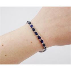 18ct white gold sapphire and diamond bracelet, twenty-six oval cut sapphires, each spaced by two round brilliant cut diamonds, stamped 750, total sapphire weight 10.60 carat, total diamond weight 0.46 carat