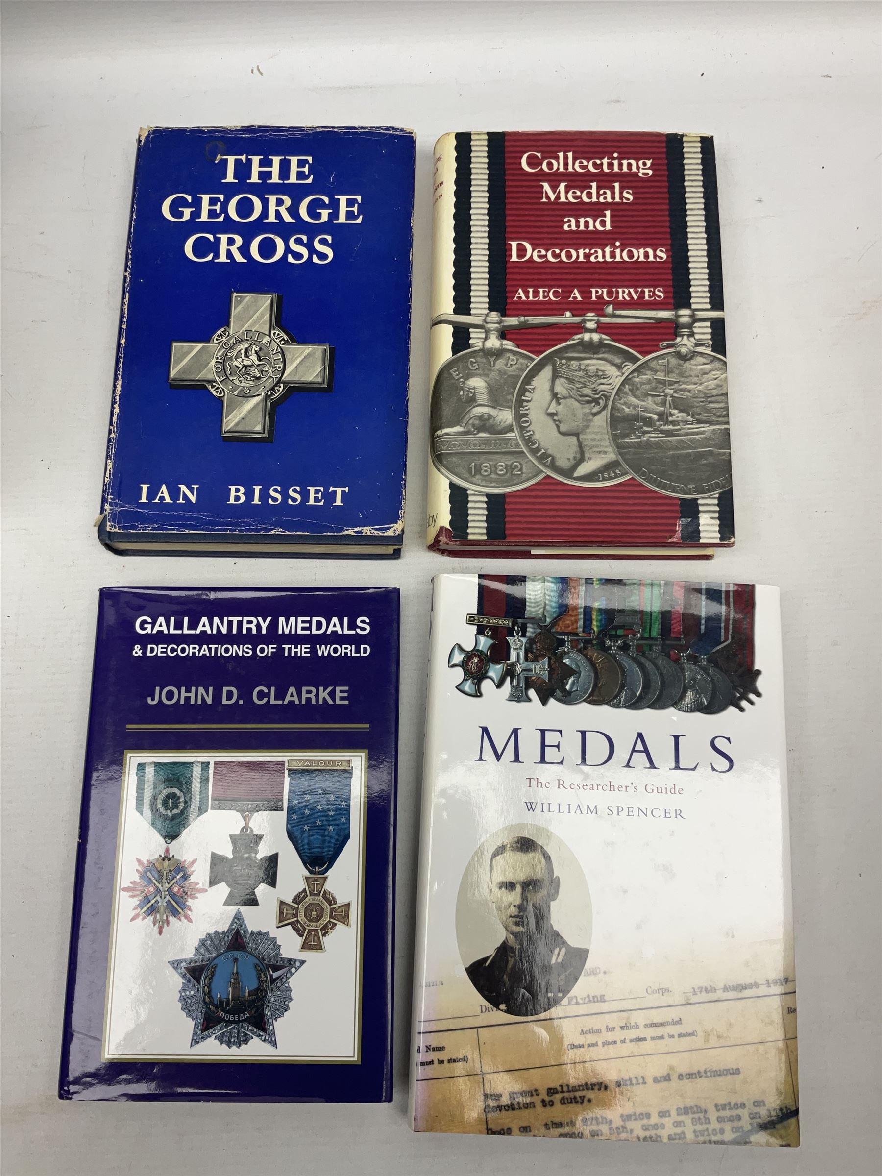 Eleven medal reference books including Ian Bisset: The George Cross; Spinks British Battles & Medals; William Spencer: Medals - The Researchers Guide; John D. Clarke: Gallantry Medals & Decorations of the World; Officers of The Green Howards 1931-1972; and six others (11)