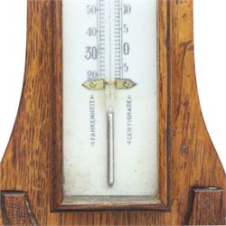 Late Victorian carved oak aneroid barometer, the foliate crest above a glazed thermometer and circular dial, with further carved decoration below, H 75cm