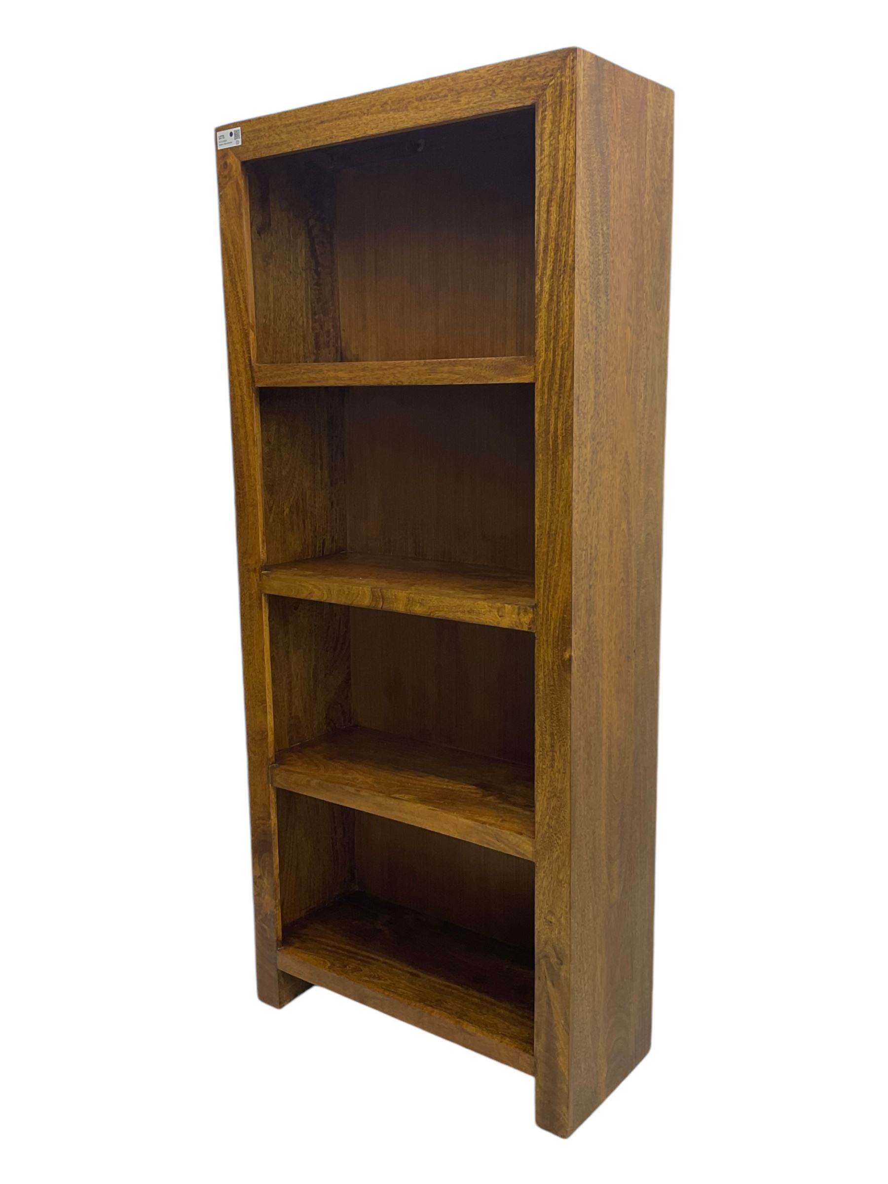 Contemporary Dakota mango wood open bookcase, rectangular form with four fixed open shelves, raised on stile supports