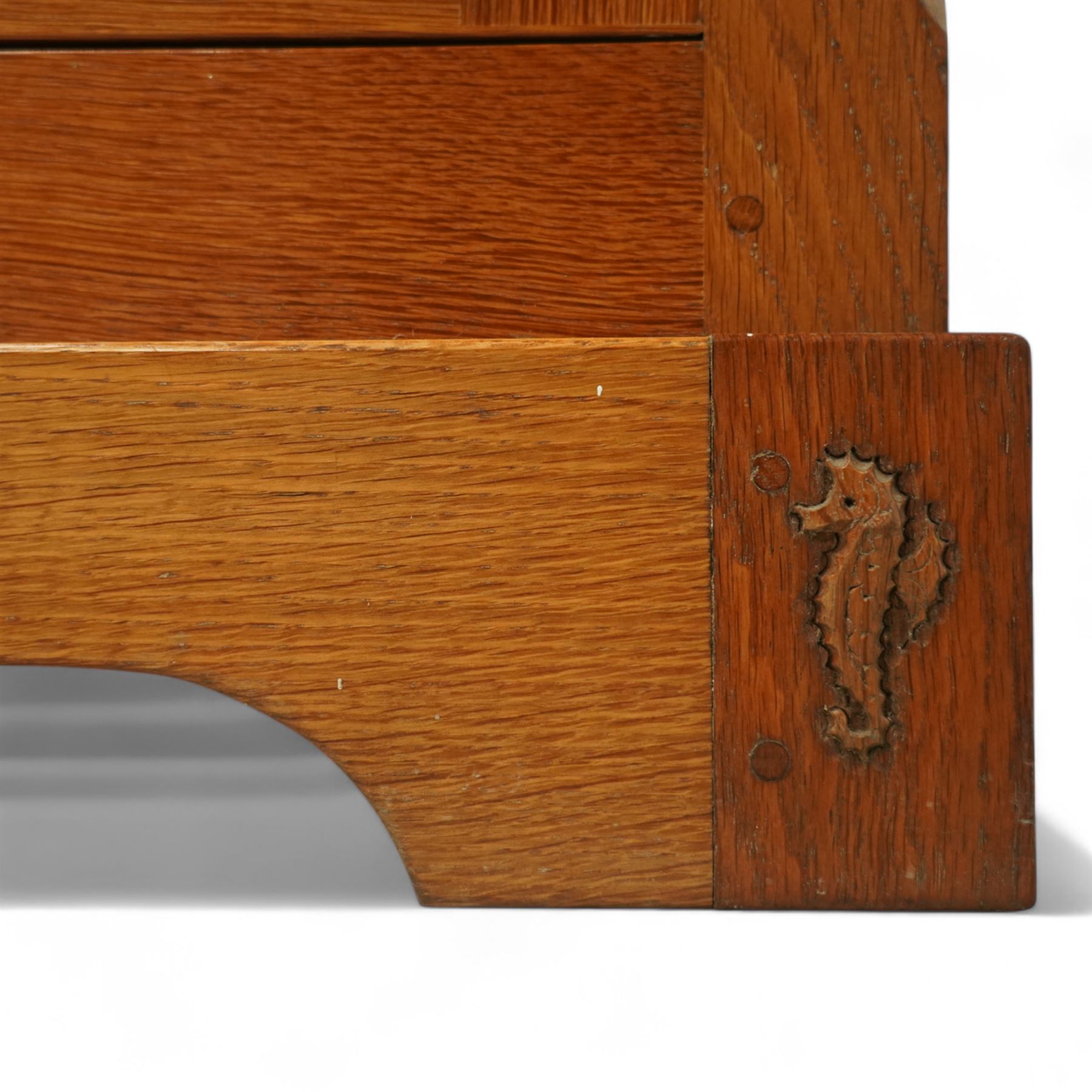 Seahorseman by Shaw & Riley - Yorkshire oak Welsh dresser, the dresser rack of rectilinear form with plain frieze and projecting moulded edge above two shelves with central shallow groove, the base section fitted with four drawers and a fitted cutlery drawer containing cutlery, above four panelled cupboard doors with geometric mouldings and carved sculpted handles, interior with single shelf and sides with geometric mouldings raised on a shallow plinth base with shaped bracket feet, with signature Seahorse carving from the workshop from the workshop of A. Shaw & Riley Ltd, Hessay