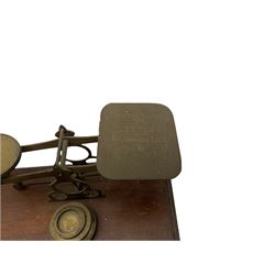 Brass postal scales with rates displayed and three weights