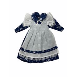 Heidi Ott doll in tartan dress, navy floral dress with white lace and ribbon detailing, striped blue and white dress and a 'Head to Toe' book