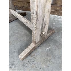 Pair of late 19th century pitch pine trestles, square tapering form in stripped finish
