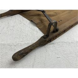WW1 British casualty stretcher with iron mounted pitch pine sides and canvas base; stamped 'HL1917' and L7 with broad arrow in a triangle L236cm ( reputedly recovered from a barn at Bapaume on The Somme)