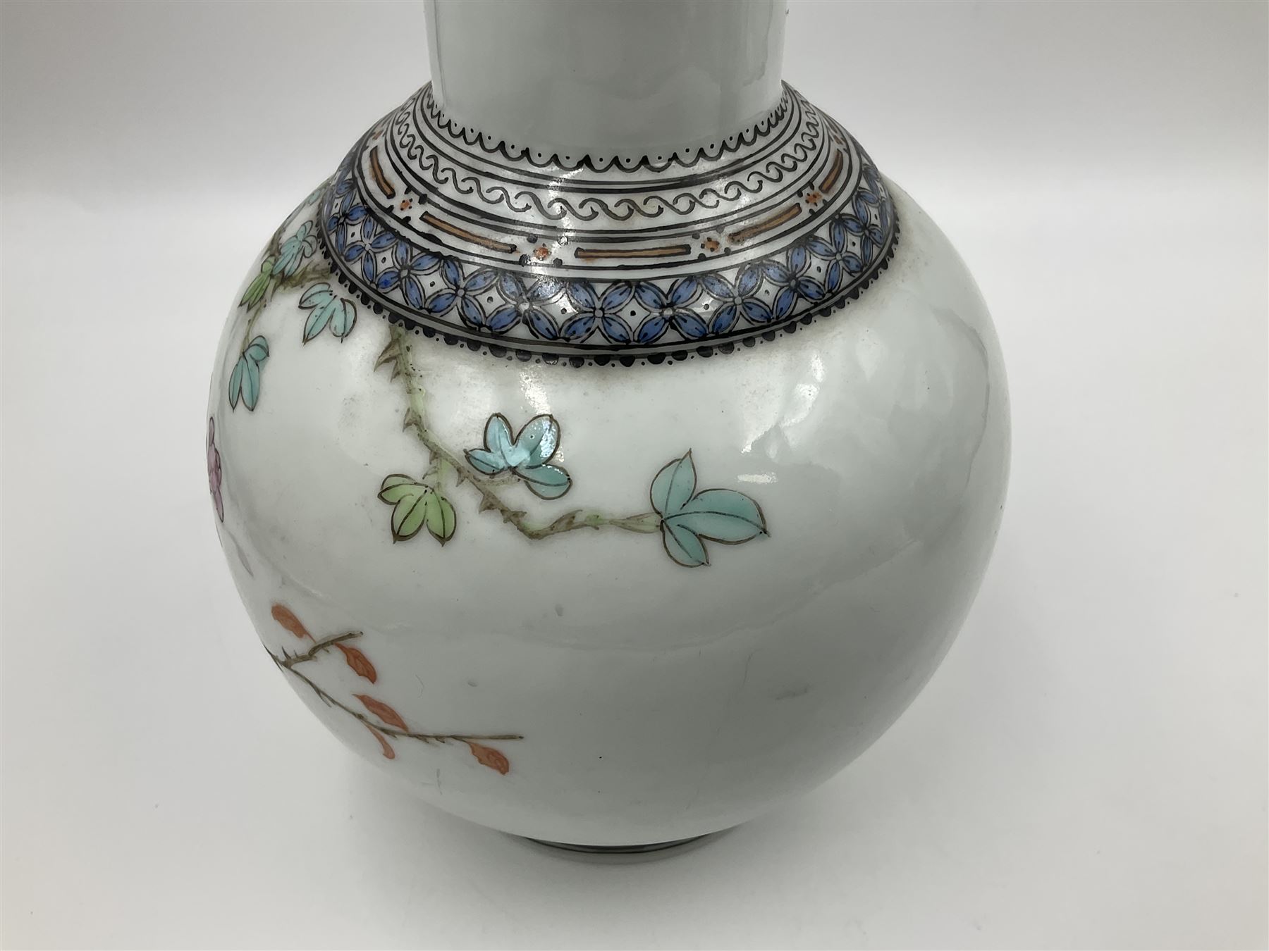 Pair of Chinese Republic porcelain vases, each painted in Famille Rose enamels with pairs of pigeons amidst peony, rock, flowering plants and leafy branches, possibly Qianlong seal beneath, H22cm 