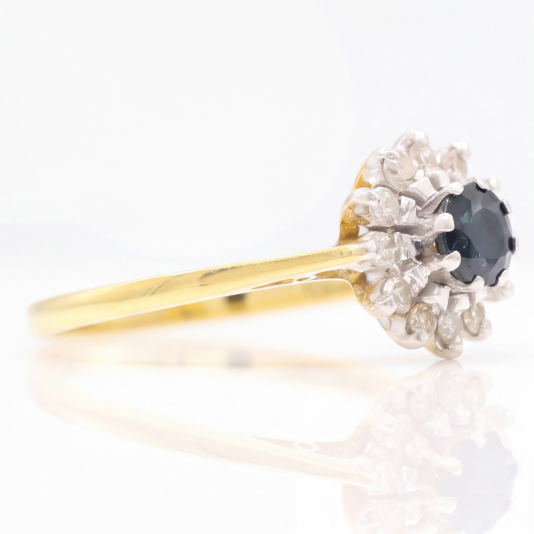 18ct gold sapphire and diamond cluster ring, single round cut sapphire surrounded by twelve single cut diamonds, Birmingham 1985