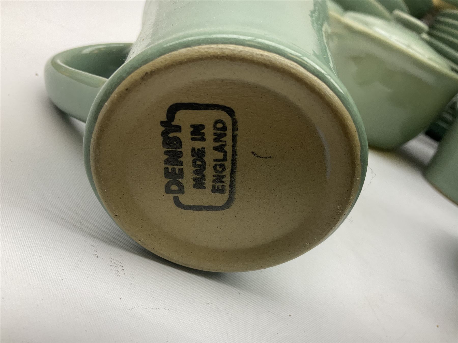 Denby Manor Green pattern part tea and dinner service, to include seven dinner plates, thirteen side plates, ten dessert plates, two oval dishes of various sizes, four cups and saucers, seven bowls with covers, two teapots etc (74)  