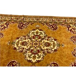 Pair Persian design amber ground rugs, central floral medallion with matching spandrels, surrounded by a multi-band foliate border
