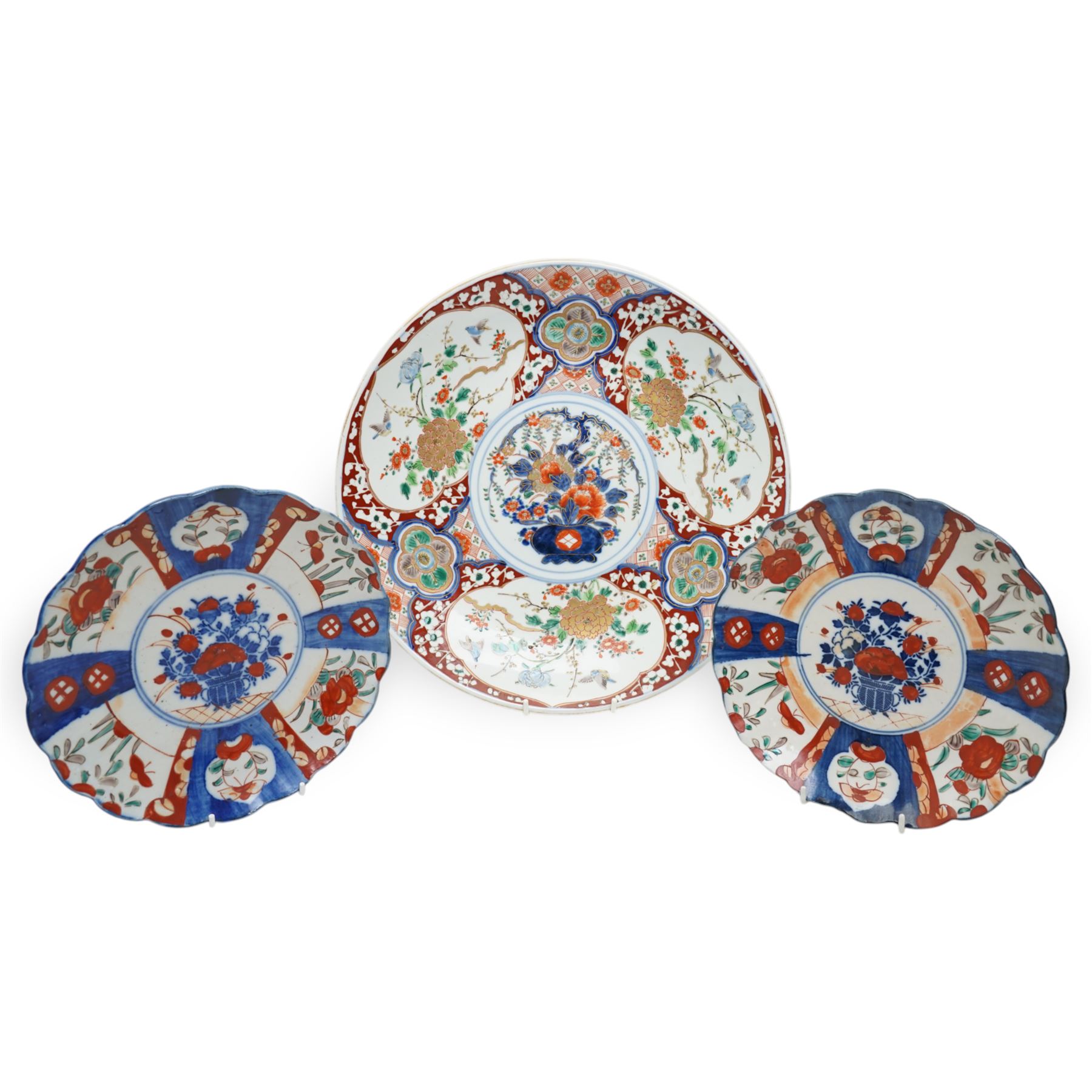 Japanese Imari charger decorated with panels of birds and flowers in orange, blue and red etc D37cm and two smaller Imari plates D21cm (3) 