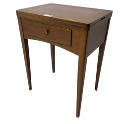 Mid-20th century teak sewing table, rectangular top with hinged fold-out extension revealing built-in Singer sewing machine, fitted with single hinged drawer, on square tapered supports; various Singer accessories to include Fashion Discs and Motor Controller