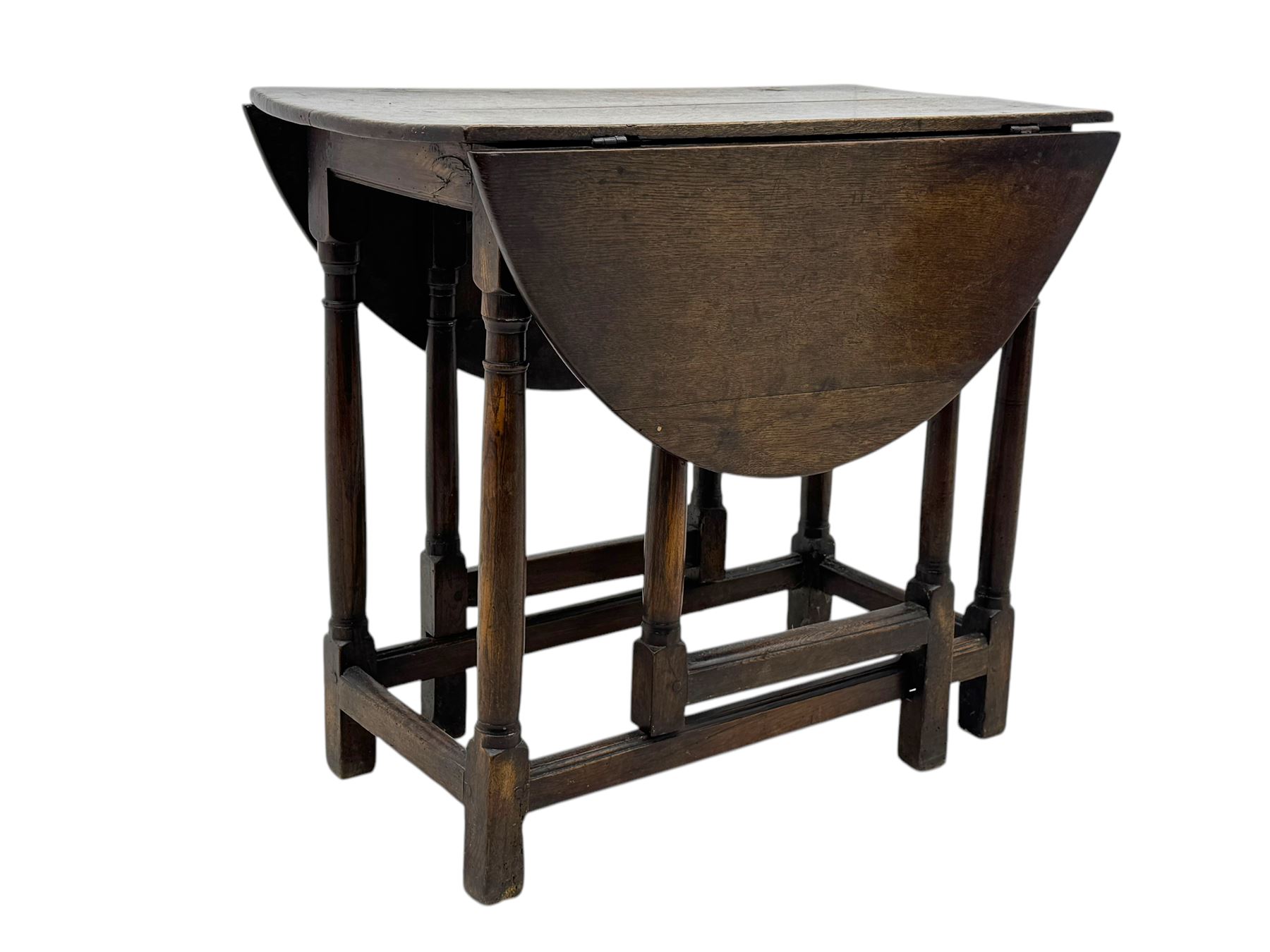 19th century oak gateleg table, the oval drop-leaf top formed of four planks, on turned column supports united by rectangular stretchers
