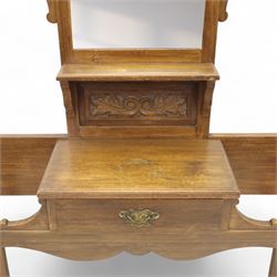 Edwardian walnut hall stand, the shaped pediment above turned spindle gallery and bevelled mirror, fitted with brass double coat hooks, single drawer with cast handle and carved frieze, flanked by turned supports, lower platform fitted with twin metal drip trays