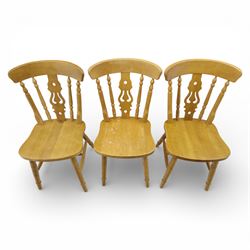 Solid oak dining table and set of seven pine farmhouse chairs including two carvers, rectangular top with tongue and groove style finish, supported a 'H' stretcher with square chamfered legs, pine farmhouse chairs with central splat and turned legs