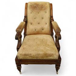 William IV mahogany gentleman's library reclining armchair, leather button upholstered and brass-studded back and seat, above leather-covered arms terminating with carved roundels and foliate scroll-carved ends, underside with brass mechanical trigger reclining lever, the apron with retractable foot rest, supported on lappet carved and turned legs with brass castors, circa 1835